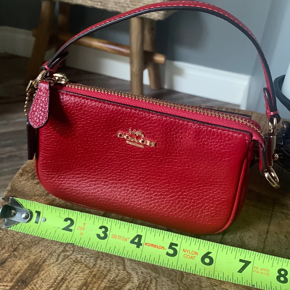 Coach Nolita 15 mini pouch with gold hardware and strap.